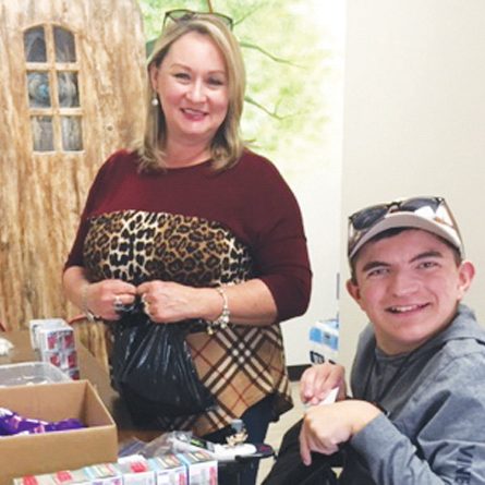 Submitted photo   Community Care Clinic volunteers Lisa Black and her son, Nicholas, pack personal care bags that will be sent to other nonprofits as part of the 49 Days of Gratitude.