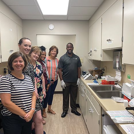 Amy Wilson, Caroline Parrott, Cathy Teat, DeAnna Turner, Krista Woolly, and a training representative stand next to the testing machine and supplies provided through the grant. Photo submitted.
