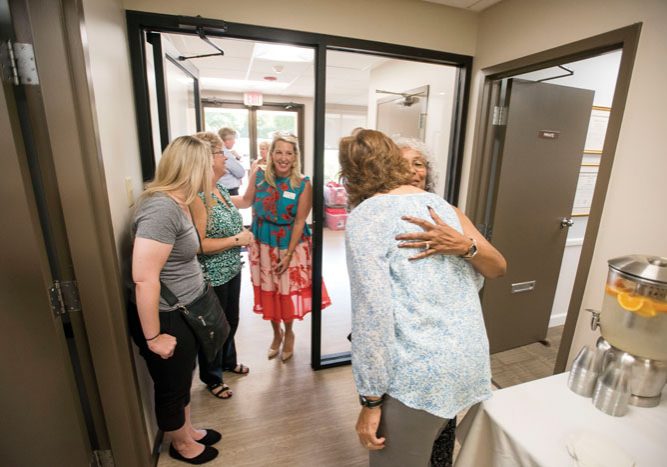 JON C. LAKEY/SALISBURY POST Clinic Excutive Director Krista Wooly (back to camera) gets a hug from P.J. Ricks before a tour. .  The Community Care Clinic on Old Mocksville Road held an open house to show off the recent remodel to supporters. With a fresh coat of paint, new floors, energy efficent lighting plus a security system are a few of the up grades to the heavily used faclity, The clinic provides primary medical and dental care as well as prescription medications to qualified under served and uninsured adults in Rowan County.  Salisbury, NC 9/9/19