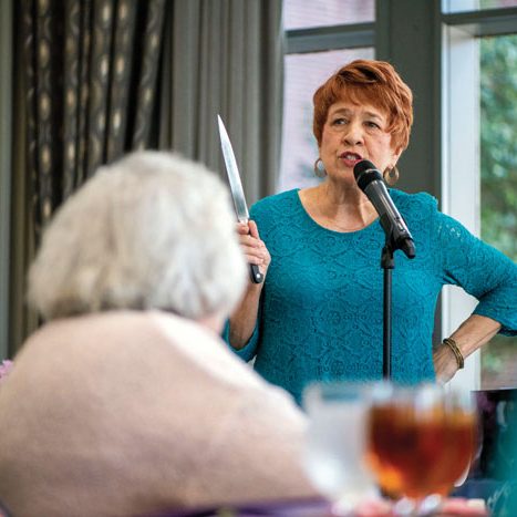 JON C. LAKEY/SALISBURY POST Mary Ann McCubbin entertains the attendees.  The annual Fashions for a Cause  was held at the Crystal Lounge at Catawba College on  Wednesday, April 10, benefitting Community Care Clinic. Salisbury, NC 4/10/19